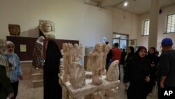 People visit the Iraqi National Museum in Baghdad, Iraq, Friday, Feb. 24, 2023, which reopened to the public after months or maintenance work.