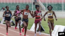 Kenyan runners Mary Moraa, right, Sarah Moraa, second from right, and Lilian Odira, center, fight for the lead in the women's 800-meter final during the Kenya Athletics Olympic Trials at Nyayo National Stadium in Nairobi, on June 14, 2024.