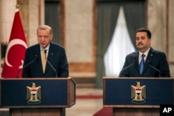 Turkish President Recep Tayyip Erdogan, left, and Iraqi Prime Minister Mohammed Shia al-Sudani speak to reporters in Baghdad, April 22, 2024. Erdogan was making his first official visit in more than a decade. (Pool / AP)
