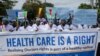 FILE - Kenyan doctors chant outside the health ministry headquarters protesting with placards to demand better pay and working conditions in the capital, Nairobi, Kenya, April 9, 2024.
