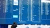 A man takes a photograph of the election results at the National Results Operation Centre of the IEC in Midrand, South Africa, June 2, 2024. 