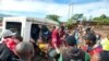 Paramedics carry a woman injured during flooding, in Kamuchiri village, Mai Mahiu, Nakuru County, Kenya, April 29, 2024.