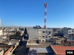 The Kurdish town of Amuda in northeast Syria lies about 2 kilometers (just over 1 mile) from the border with Turkey, March 25, 2024. Turkish mountains can be seen in the background. (Sirwan Kajjo/VOA)