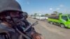 FILE - In this image made from video, police patrol a road in Palma, Cabo Delgado province, Mozambique, Aug. 15, 2021. The United Nations says jihadist violence in the region has forced more than a million people to flee their homes. 