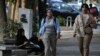 FILE - Iranian women walk in Tehran, Iran, neither wearing a hijab, on Aug. 5, 2023. Iran's parliament has passed legislation that imposes severe penalties for hijab violations. The law is to take effect Dec. 13, 2024.