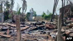 FILE - A destroyed house and burned trees are seen following fighting between Myanmar's military and the Arakan Army ethnic minority armed group in a village in Minbya Township in western Rakhine State, May 21, 2024.
