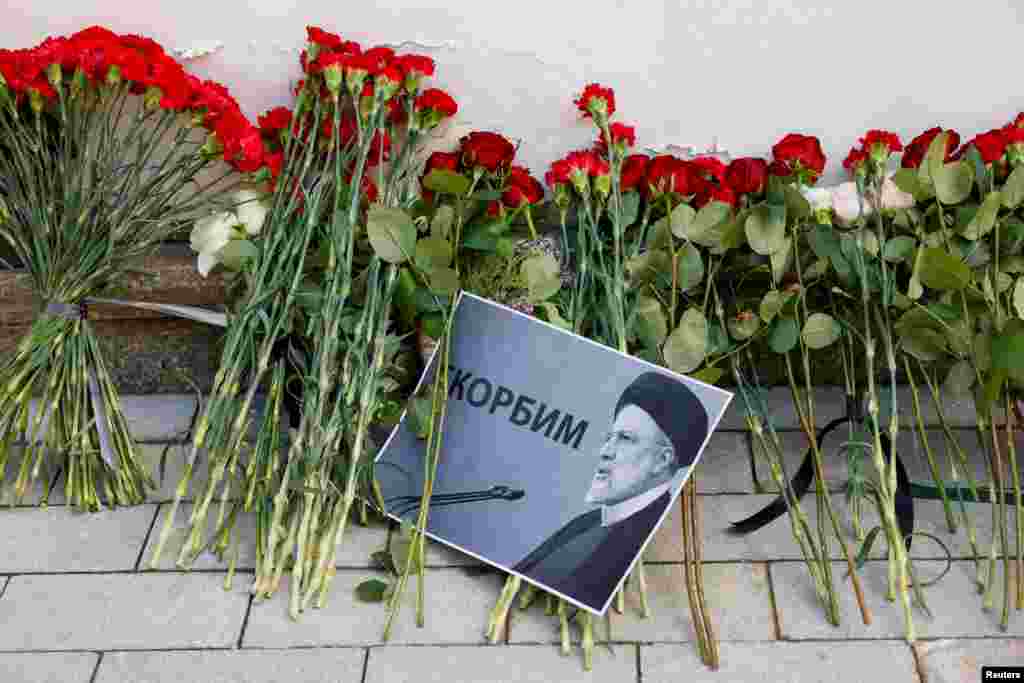 A view shows flowers outside the Iranian embassy in Moscow, Russia, placed to pay tribute to Iran's President Ebrahim Raisi, Foreign Minister Hossein Amirabdollahian and other victims of a recent helicopter crash in mountainous terrain near Iran's border with Azerbaijan, May 20, 2024.