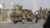 FILE - A security force patrols the streets during fighting between al-Shabab extremists and soldiers in Mogadishu, Somalia, Feb. 21, 2023.