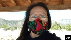 FILE - In this photo provided by Albertyn Pino, Pino poses for a selfie in Laguna Pueblo, NM, Oct. 17, 2020.