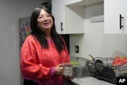 Celina Chanthanouvong poses in her apartment in Emeryville, California, on June 2, 2023.