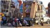 Afghan refugees, along with their belongings, sit beside the trucks at a registration center upon their arrival from Pakistan in Takhta Pul district of Kandahar province on Dec. 18, 2023.