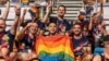 FILE - Participants wave rainbow flags during the opening ceremony of the Gay Games in Hong Kong, Nov. 4, 2023. 