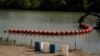 Biden Administration Sues Texas Over Floating Barrier Meant to Stop Migrants
