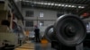 FILE - A worker checks on a cargo train wheel at the GEMAC Engineering Machinery during a media-organized tour in Xiangyang in China's Hubei Province, May 10, 2023. Chinese leader Xi Jinping promised to build more railway and trade links with Central Asia at a meeting May 19. 