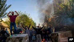 In this photo taken by an individual not employed by the Associated Press and obtained by the AP outside Iran, Iranians protests the death of 22-year-old Mahsa Amini after she was detained by the morality police last month, in Tehran, Oct. 27, 2022.