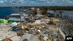 An aerial picture taken on Oct. 1, 2022 shows a broken section of the Pine Island Road, debris and destroyed houses in the aftermath of Hurricane Ian in Matlacha, Florida. 