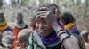 FILE - A woman waits for food distributed by the United States Agency for International Development in Kenya, July 23, 2022. Climate change and a growing world population may threaten global food security. Changes in agriculture, especially in Africa, may be the only way forward.
