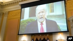 FILE - A video of President Donald Trump is shown on a screen, as the House select committee investigating the January 6 attack on the U.S. Capitol holds a hearing at the Capitol in Washington, July 21, 2022.