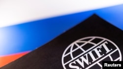 Swift logo is placed on a Russian flag are seen in this illustration taken, Bosnia and Herzegovina, February 25, 2022. REUTERS/Dado Ruvic/Illustration