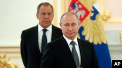 Russian President Vladimir Putin, center, and Russian Foreign Minister Sergei Lavrov attend a ceremony to receive credentials from newly appointed foreign ambassadors to Russia in Kremlin, Moscow, Russia, Wednesday, July 3, 2019. (Maxim Shipenkov/Pool Photo via AP)