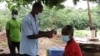FILE - A villager in southern Malawi readies for a COVID-19 shot on Jan. 18, 2022. The country launched a new vaccination campaign on Jan. 29, 2024. (Lameck Masina/VOA)