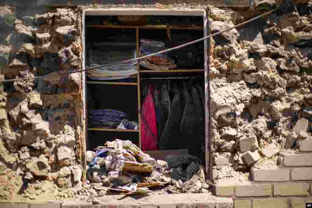 Clothes remain hung in a closet of a destroyed house after a Russian rocket, hit by Ukraine's anti-aircraft system, struck a residential area in Zaporizhzhia, Ukraine.
