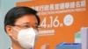 Former Hong Kong Chief Secretary John Lee poses for a photograph before submitting his candidacy for the Election of the Chief Executive, in Hong Kong, April 13, 2022. 