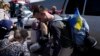 A group of Ukrainian refugees arrive at a shelter in the border city of Tijuana, Mexico, April 21, 2022, hoping to gain entry into the United States.