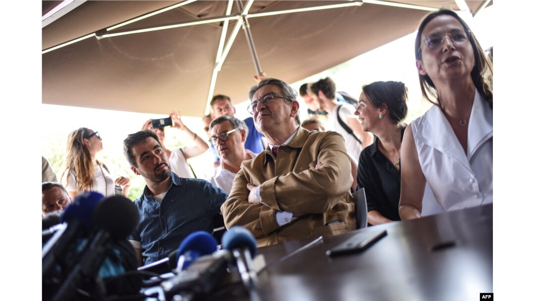 The leader of French leftist electoral coalition Nupes (Nouvelle Union populaire ecologique et sociale) Jean-Luc Melenchon (C) addresses a press conference as part of a campaign visit in Nantes, western France, May 17, 2022.