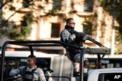 Security personnel guard the prosecutor's building where Ovidio Guzmán, one of the sons of former Sinaloa cartel boss Joaquin "El Chapo" Guzman, is in custody in Mexico City, Jan. 5, 2023.