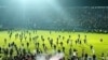 Tangkapan layar video AFPTV yang diambil pada 1 Oktober 2022 menunjukkan gas air mata yang disemprotkan di kerumunan saat suporter berlarian di lapangan setelah pertandingan sepak bola antara Arema FC dan Persebaya Surabaya di Stadion Kanjuruhan di Malang