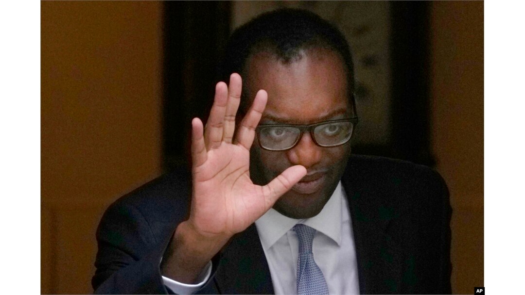 Britain's former Chancellor of the Exchequer Kwasi Kwarteng waves to the media as he leaves 11 Downing Street after being sacked by the Prime Minister Liz Truss in London.