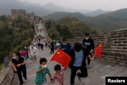 中國國旗日遊客手拿國旗爬長城。 （2022年10月1日）