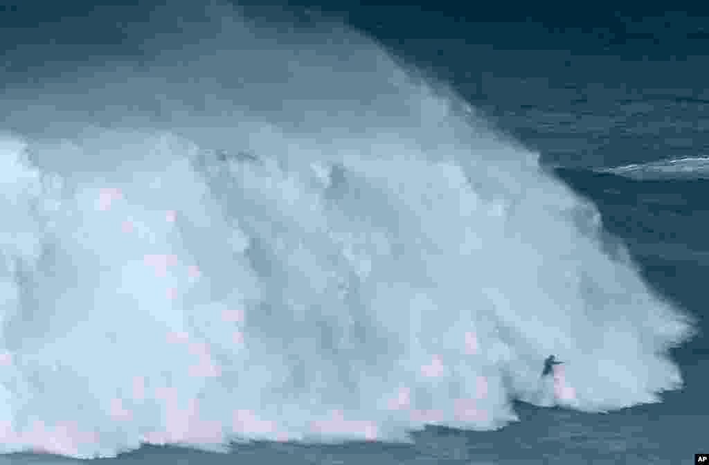 Brazilian surfer Maya Gabeira rides a wave during a big wave surfing session at the Praia do Norte, or North beach, in Nazare, Portugal, Oct. 21, 2017.