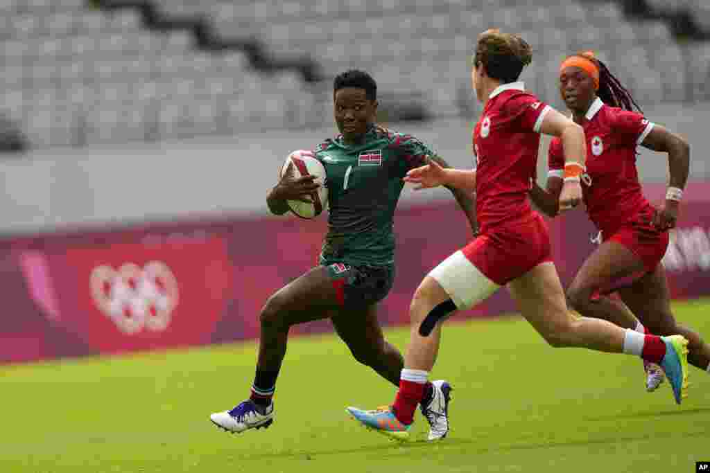 Kenya's Leah Wambui, left, is pursued by Canada's Ghislaine Landry, second right, and Charity Williams, in their women's rugby sevens 9-10 placing match at the 2020 Summer Olympics, Saturday, July 31, 2021 in Tokyo, Japan. (AP Photo/Shuji Kajiyama)