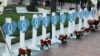 FILE - The names of 11 victims are written on hearts as people gather for a candlelight vigil after a mass shooting during Chinese Lunar New Year celebrations in Monterey Park, California, Jan. 24, 2023. 