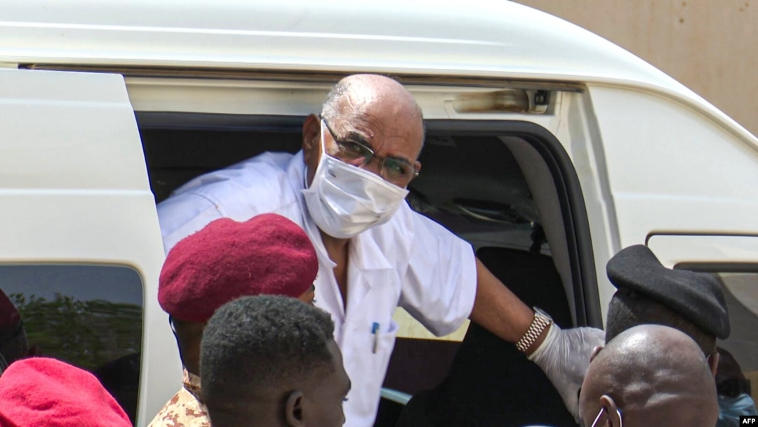 FILE - Sudan's ousted President Omar al-Bashir disembarks from a vehicle upon arriving at the courthouse to attend his trial, in the capital Khartoum, in this AFPTV screen grab from footage aired July 21, 2020. 