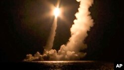 FILE - In this photo taken from video distributed by Russian Defense Ministry Press Service, Intercontinental ballistic missiles are launched by the Vladimir Monomakh nuclear submarine of the Russian navy from the Sera of Okhotsk, Russia, on Dec. 12, 2020. 
