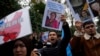 Protesters chant slogans as they hold posters and pictures of victims during a protest against China's brutal crackdown on ethnic group Uyghurs, in front of the Chinese consulate in Istanbul, Turkey, Nov. 30, 2022. 
