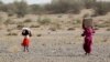 FILE - Yemenis displaced by conflict receive food aid and provisions to meet their basic needs at a camp in the Khokha district of Yemen's war-ravaged western province of Hodeida, Jan. 31, 2022. 