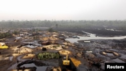 FILE - General view shows an oil stained polluted mangrove in Bakana ii, Okrika local government area, Rivers state, Nigeria Jan. 28, 2022. 