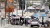FILE - Somali security forces secure the road leading to the scene of an explosion at a checkpoint near the Presidential palace in Mogadishu, Somalia, Feb. 10, 2022. 