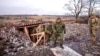 FILE - Russian Defense Minister Sergei Shoigu, center, walks out of a trench, escorted by a group of officers as he inspects Russian troops at an undisclosed location in Ukraine, Dec. 22, 2022, in this photo taken from video released by Russian Defense Ministry Press Service.