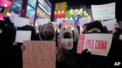 Demonstrators stage a solidarity rally to denounce the Chinese government's continued zero-COVID policies, in Seoul, South Korea, Nov. 30, 2022. 