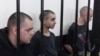 Фото: громадяни  Британії Ейден Еслін та Шон Піннер та громадянин Марокко Брагім Саадун в проросійському суді в Донецьку, 9 червня 2022 року. (AP Photo)