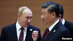 FILE - Russian President Vladimir Putin speaks with Chinese President Xi Jinping at the Shanghai Cooperation Organization summit in Samarkand, Uzbekistan, Sept. 16, 2022. (Sergei Bobylev, Sputnik, Kremlin Pool Photo via AP)