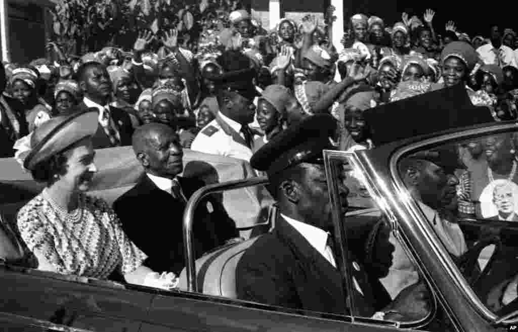 Thousands of Malawian women cheer and wave their hands at Britain's Queen Elizabeth II and Malawi's President Hastings Banda as they drive from the airport in Blantyre, Malawi on July 22, 1979.the Queen is on the second leg of her four-nation African tour. (AP Photo)
