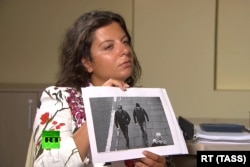RUSSIA -- RT Editor-in-Chief Margarita Simonyan shows an image of two men during an interview with Aleksandr Petrov and Ruslan Boshirov, who are suspected by the British authorities of poisoning former GRU officer Sergei Skripal and his daughter Yulia.