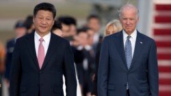 Chinese President Xi Jinping and Vice President Joe Biden walk down the red carpet on the tarmac during an arrival ceremony in Andrews Air Force Base, Md., Thursday, Sept. 24, 2015.