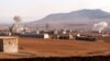 FILE - Smoke rises from bombardment amid battles between the Turkish-backed Syrian National Army faction and the Kurdish-led Syrian Democratic Forces at a position near the Tishrin Dam in the vicinity of Manbij, in the east of Syria's northern Aleppo province, Jan. 10, 2025. 